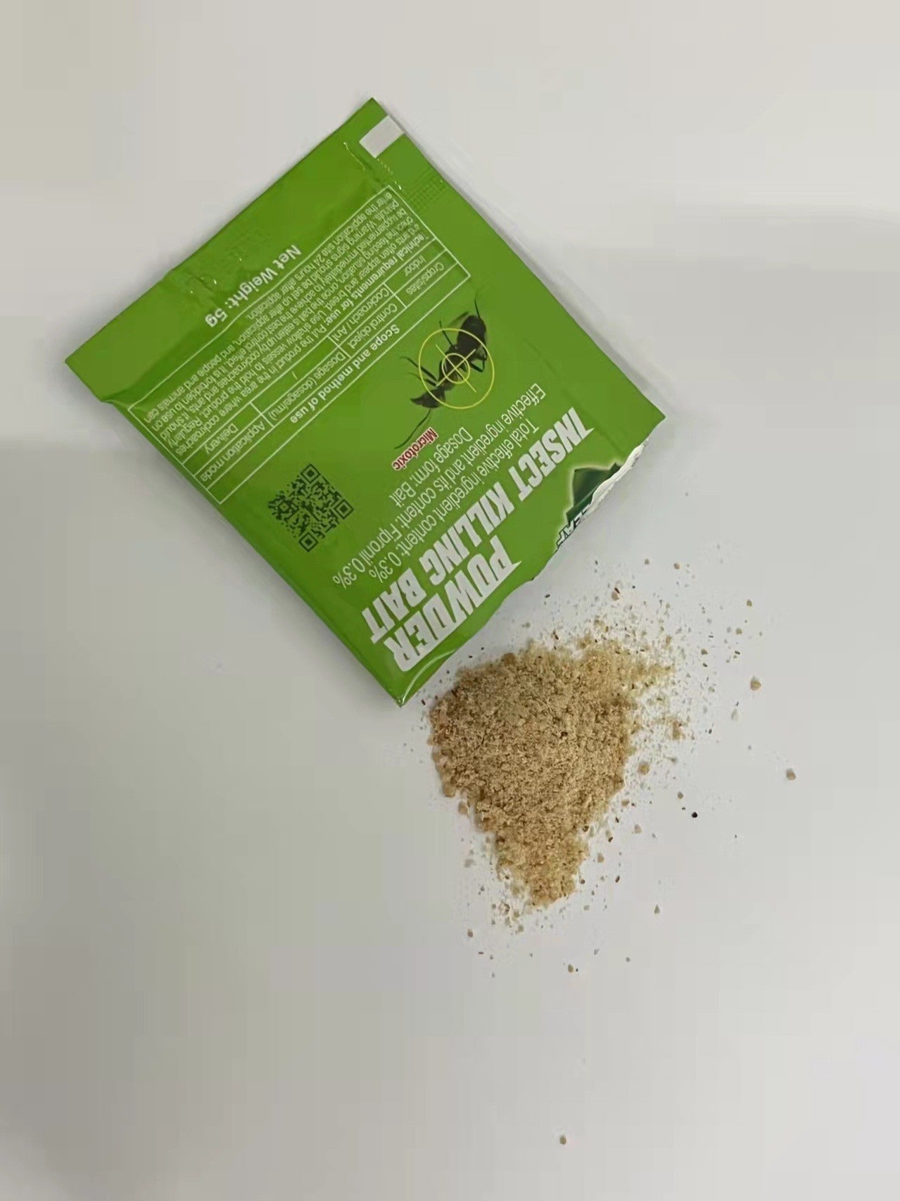 Powder cockroach killing bait pack with spilled contents on a white background for effective pest control